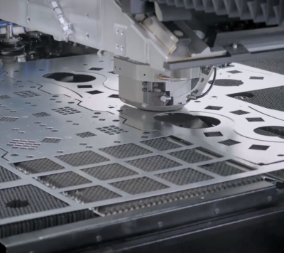 CNC turret punch press operating on a sheet of metal