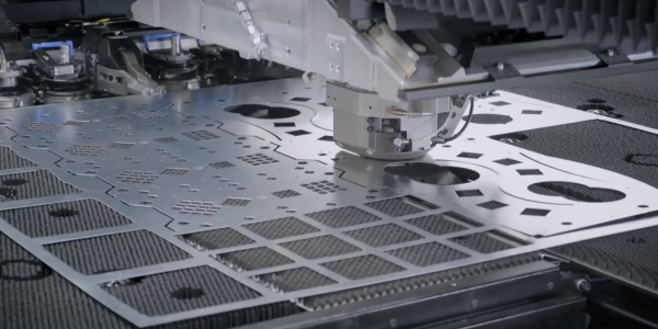 CNC turret punch press operating on a sheet of metal
